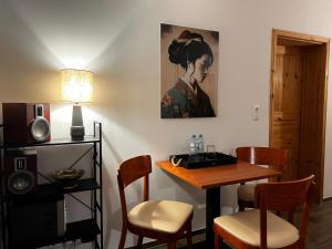 a dining room with a table and a painting on the wall at Haus am See mit Badestelle in Franzensberg