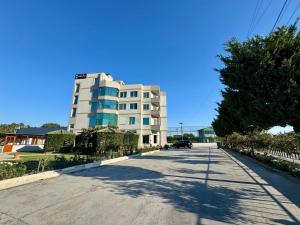 a building on the side of a road at Aerostay hotel 1 km from airport in Rinas