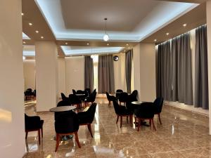 a meeting room with tables and chairs in a building at Aerostay hotel 1 km from airport in Rinas