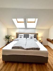 a bedroom with a large bed with skylights at Jagagütl in Saalfelden am Steinernen Meer