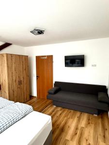 a bedroom with a bed and a couch at Jagagütl in Saalfelden am Steinernen Meer +22 photos