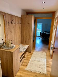 a living room with wooden cabinets and a table at Jagagütl in Saalfelden am Steinernen Meer