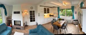 a living room with a blue couch and a table at Haus Tierlieb in Stadtkyll