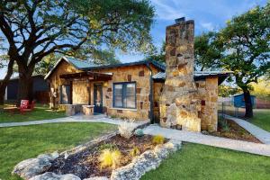 a stone house with a stone chimney in a yard at Blue Haus in Johnson City