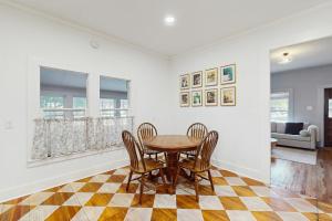 a dining room with a table and chairs on a checkered floor at Blue Haus in Johnson City