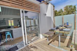 a kitchen and dining room with a table on a balcony at La maison de perros in Perros-Guirec
