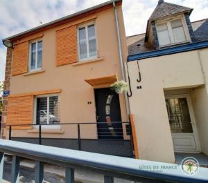 a house with a fence in front of it at La maison de perros in Perros-Guirec
