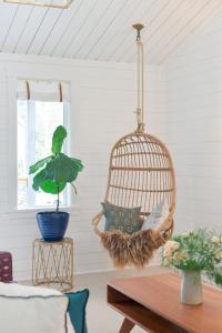 a room with a bird cage and a table at Scandinavian Cottage by the Sea, Close Walk to Ferry and Town in Winslow
