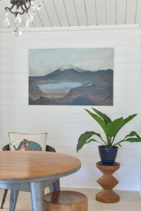 a dining room with a table and a potted plant at Scandinavian Cottage by the Sea, Close Walk to Ferry and Town in Winslow +21 photos
