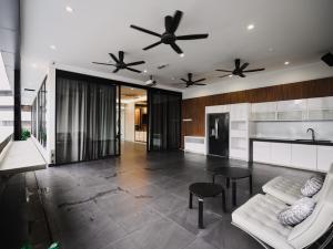 a living room with a white couch and two fans at Eco Roomy Hotel in Kuala Lumpur +90 photos
