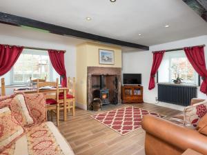 a living room with a couch and a table and a fireplace at 2 bed property in Mawbray Cumbria SZ214 in Mawbray