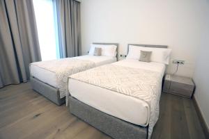 Ein Bett oder Betten in einem Zimmer der Unterkunft Cosmo Apartments Platja d'Aro