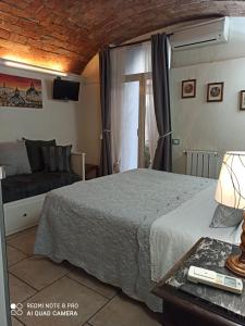 a bedroom with a bed and a couch at Citta Giardino B&B in Rome