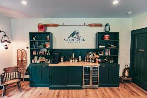 a kitchen with green cabinets and a counter at Luxury Glamping Tent - The Perch - Near Tryon Equestrain Center in Mill Spring
