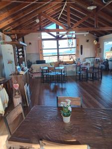 a large room with a table and some chairs at La Morada del Lago in Tolhuin