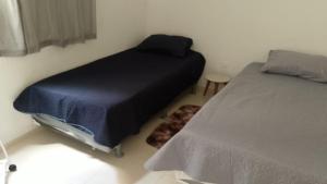 En eller flere senge i et værelse på COP 30 - apartamento 2 quartos, sala e cozinha + 2 billeder