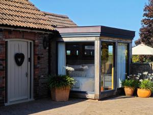 a glass house with a bed in it at Harcombe Barn near Bristol in Bristol