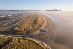 an aerial view of a beach and the ocean at Blue Heron - Modern Chef Kitchen, Hot Tub near Beach in Seaside