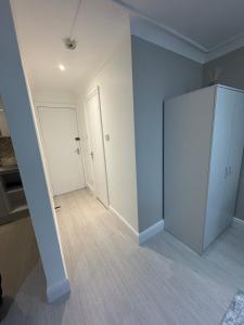 an empty room with a closet and a door at Modern Studio Apartment Shoreditch in London +9 photos