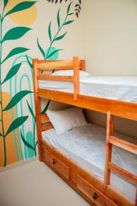 two bunk beds in a room with a mural at Eco Hotel Mãe De Sagui in Castanhal