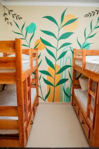 two bunk beds in a room with a mural on the wall at Eco Hotel Mãe De Sagui in Castanhal