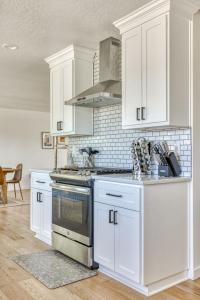 a kitchen with white cabinets and a stove top oven at Vogel Vacation - Spacious Secluded, Hot Tub & Game Room in Damascus