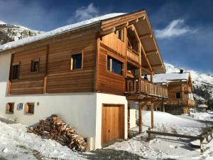 a log cabin in the snow with snow at Cozy Chalet With Scenic View In Monêtier Les Bains in Le Monêtier-les-Bains