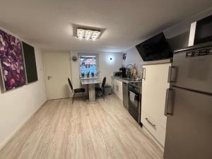 a kitchen with a refrigerator and a table in it at Kleiner Kalle in Melsungen