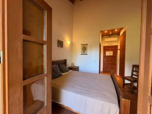 a bedroom with a bed and a chair in it at Casa de Campo Vale do Asno in Altura +63 photos