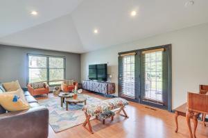 a living room with a couch and a tv at Hot Tub and Pool Family Home 5 Mi to Princeton! in Dutch Neck