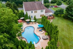 an aerial view of a house with a swimming pool at Hot Tub and Pool Family Home 5 Mi to Princeton! in Dutch Neck