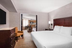 a hotel room with a large bed and a desk at Eastgate Hotel - BW Signature Collection in Bellevue