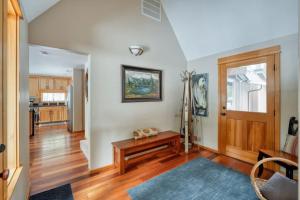 a living room with white walls and a wooden floor at Spring Home 6 - Cozy 4BR Cabin in Black Butte Ranch w Fireplace in Black Butte Ranch