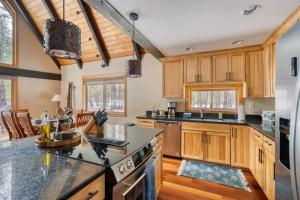 a kitchen with wooden cabinets and a counter top at Spring Home 6 - Cozy 4BR Cabin in Black Butte Ranch w Fireplace in Black Butte Ranch