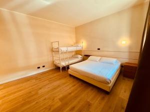 a bedroom with two bunk beds and a wooden floor at Hotel Pex Mantova in Mantova +23 photos