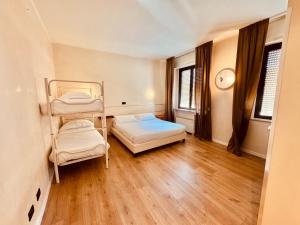 a room with two bunk beds and a clock on the wall at Hotel Pex Mantova in Mantova