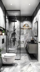 a bathroom with a shower with a toilet and a sink at FARAH RUM lUXURY CAMP in Wadi Rum