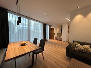 a living room with a wooden table and a couch at Ferienhaus Mayka in Hochrindl