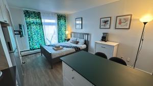 a small bedroom with a bed and a desk and a table at McGill Les petits studios in Montréal