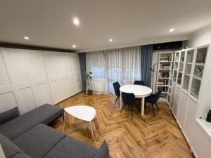 a living room with a couch and a table at Miedziane ZALESIE - Noclegi Lubin in Lubin