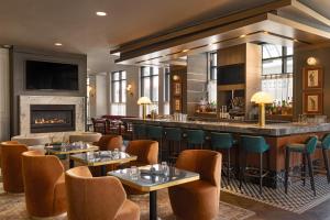 un restaurant avec un bar et une cheminée dans l'établissement Hotel Ivy, a Luxury Collection Hotel, Minneapolis, à Minneapolis