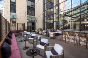 a patio with chairs and tables in a building at Hotel Ivy, a Luxury Collection Hotel, Minneapolis in Minneapolis