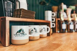 a row of coffee cups sitting on a shelf at Luxury Glamping Tent - The Perch - Near Tryon Equestrain Center in Mill Spring +22 photos
