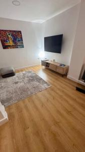 a living room with a flat screen tv on a wall at Luxury Hampstead Mews House, Close to City Centre in London