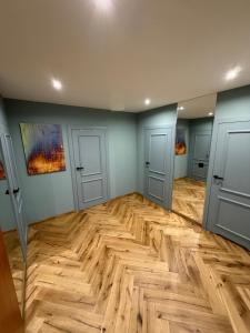 an empty room with two doors and a wooden floor at Miedziane ZALESIE - Noclegi Lubin in Lubin