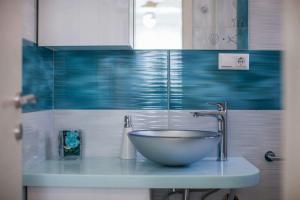 a bathroom with a bowl sink on a counter at Molo Trovna Apartments in Vis