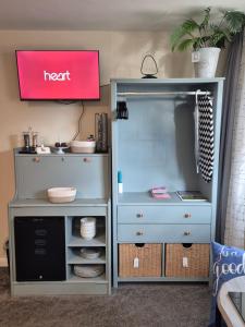 a blue dresser with a react sign above it at Heads In Beds, The Bull Room NEW LOCATION Vale of York, Carlton Miniott, Thirsk NOT in Thirsk +1 photo