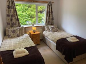 a bedroom with two twin beds and a window at Spacious holiday home with stunning sea views in Whiting Bay