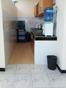 a kitchen with a sink and a counter top at Azuka Luxury in Mombasa +3 photos