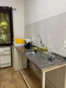 a kitchen with a sink and a counter top at Recanto do Bosque in Majé